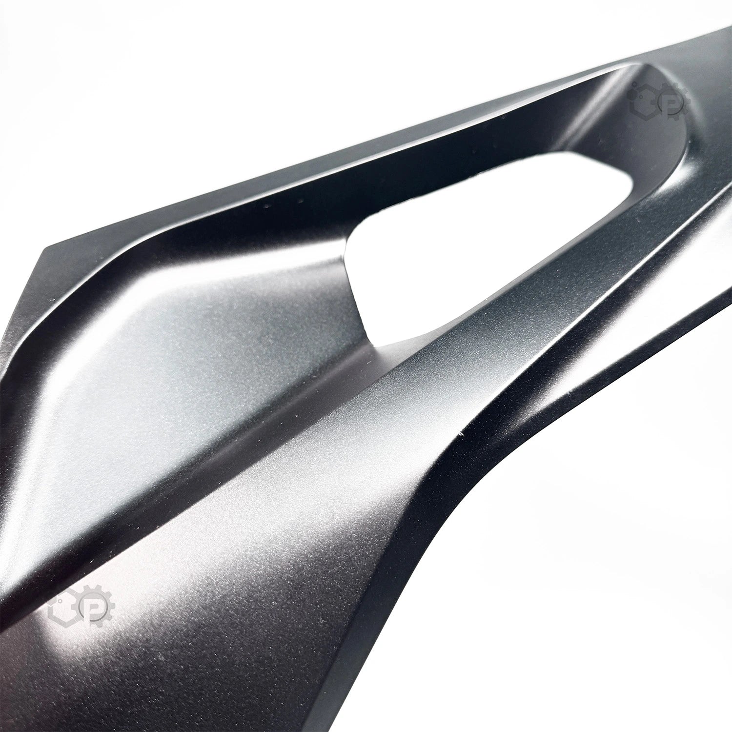 Close-up of a metallic object with a brand logo on a white background