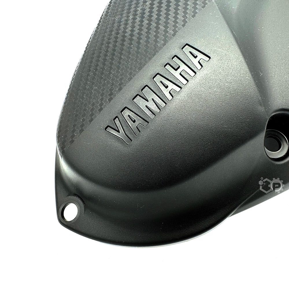 Yamaha brand logo on a motorcycle part against a white background