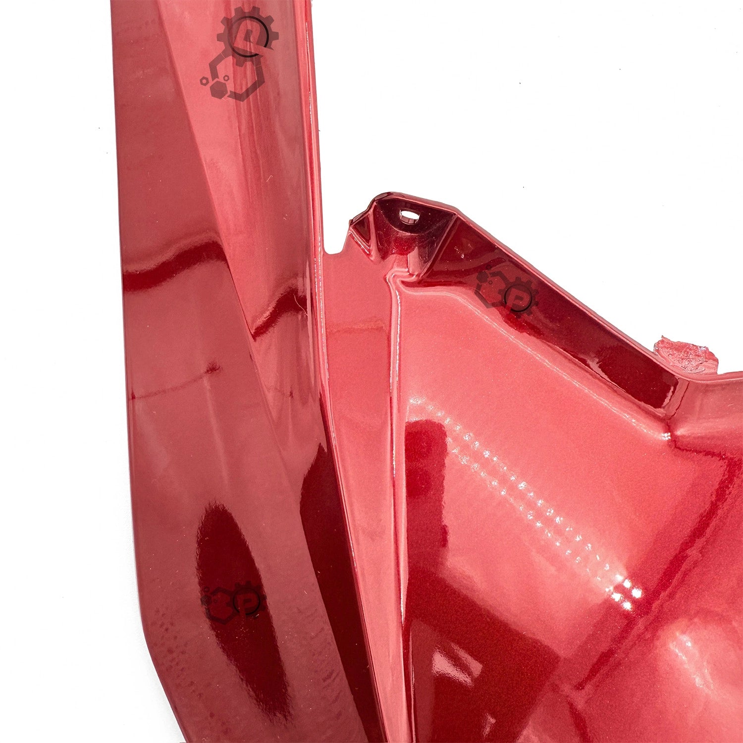 Close-up of a red plastic component with a brand logo on a white background