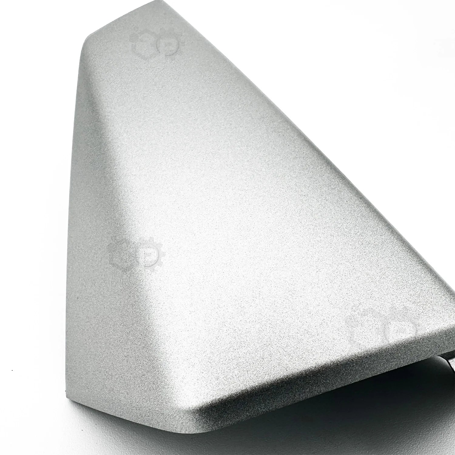Metallic object with a textured surface on a white background