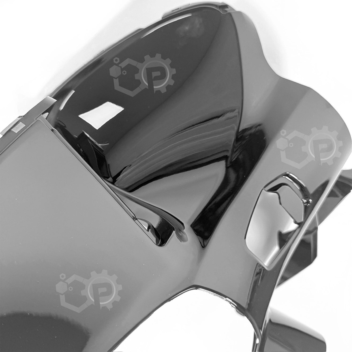 Close-up of a metallic object with a gear design on a white background