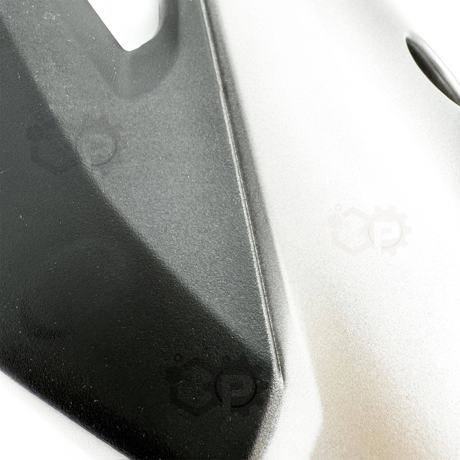 Close-up of a car's front bumper and hood on a white background