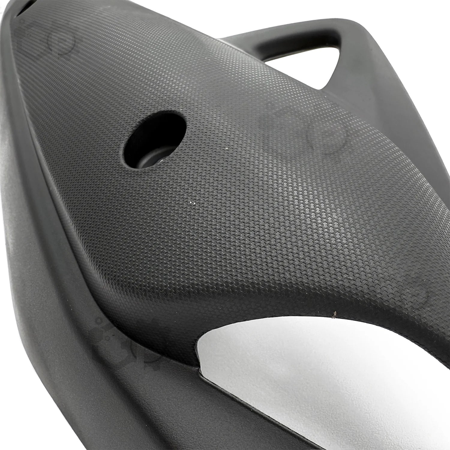 Close-up of a textured black seat with a silver trim on a white background