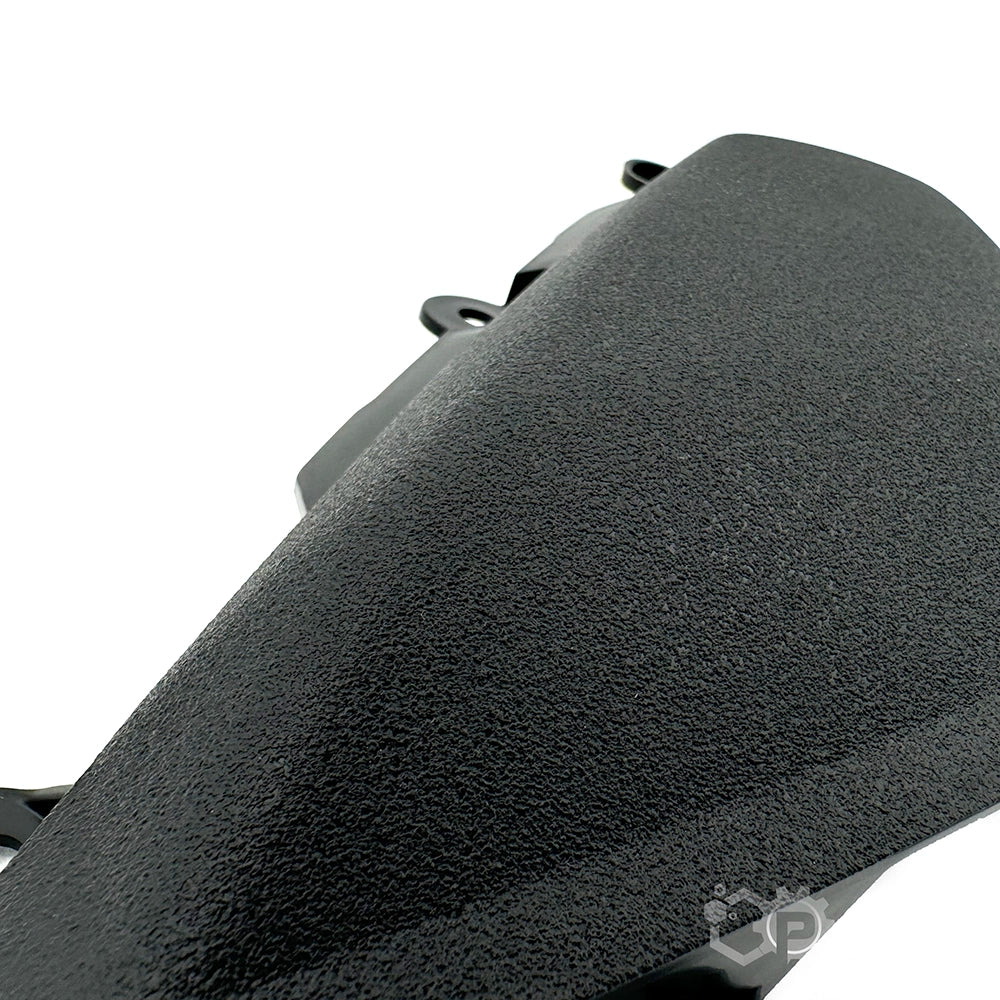 Close-up of a textured black object on a white background