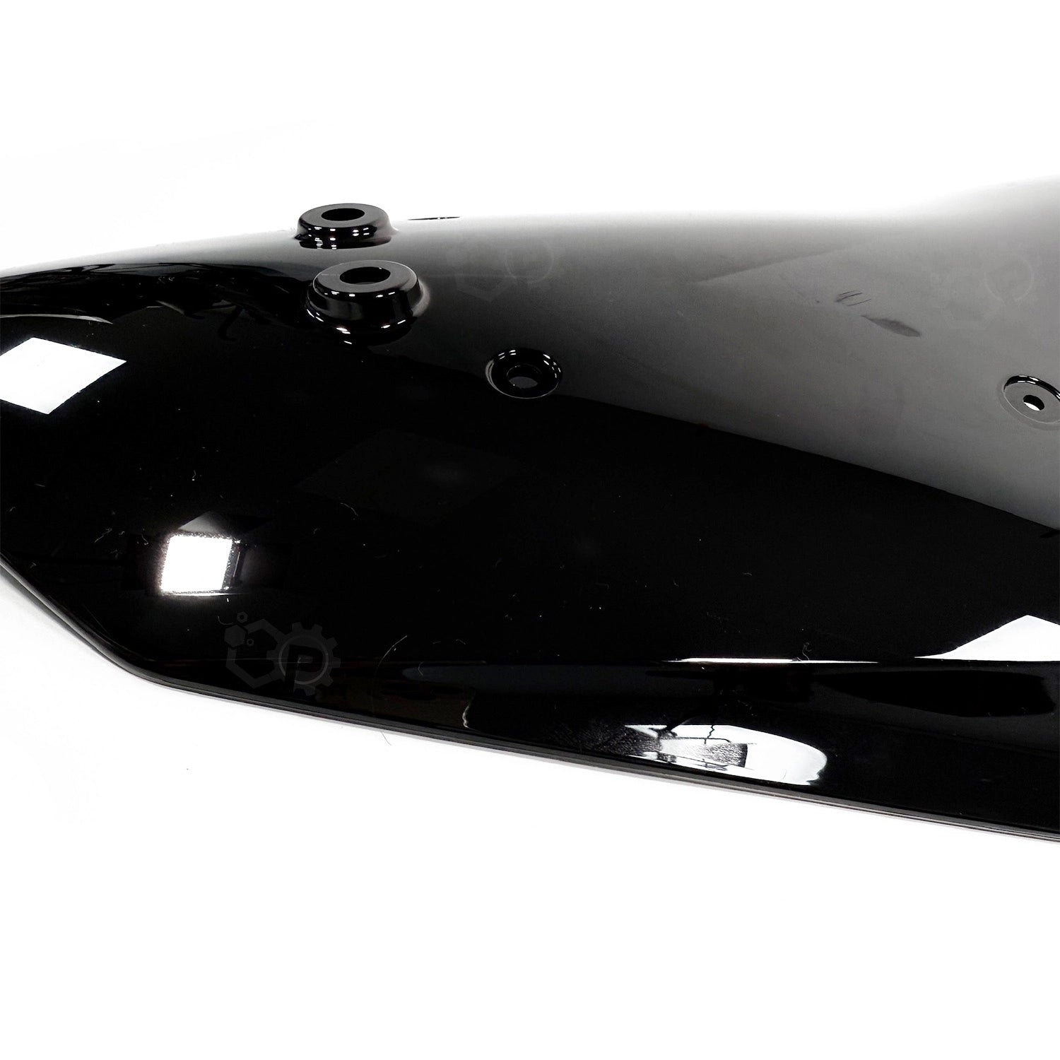 Close-up of a black motorcycle fuel tank with visible bolts on a white background