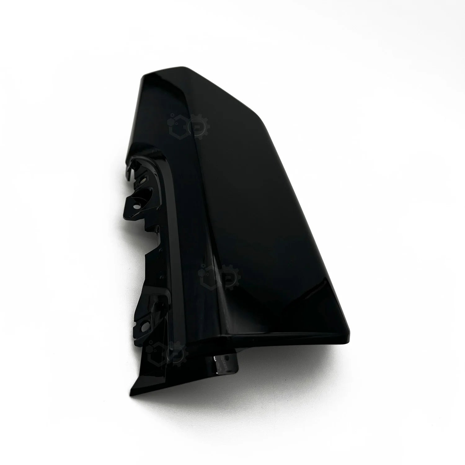 Black plastic motorbike part on a white background