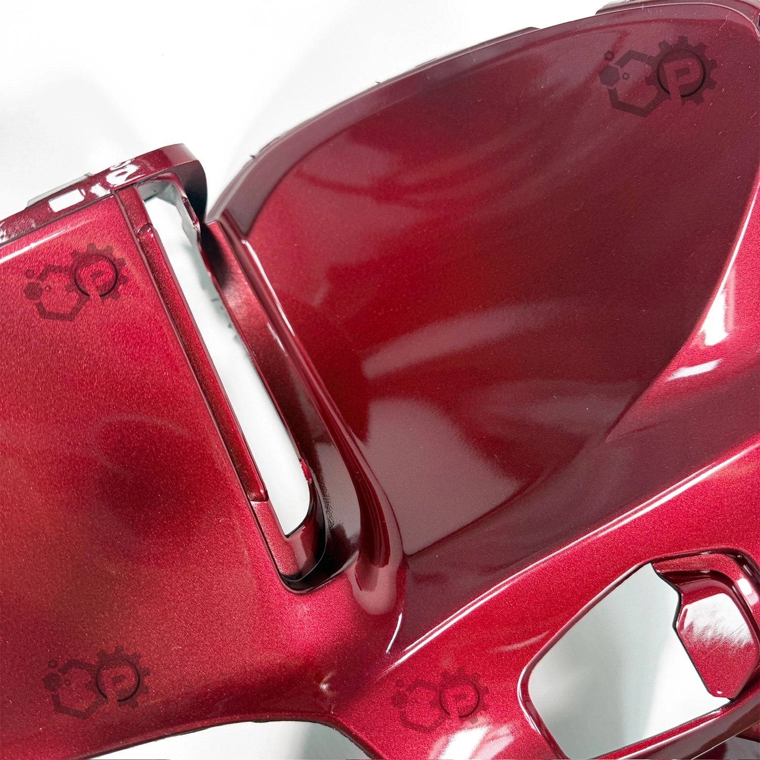 Close-up of a red object with a gear design on a white background